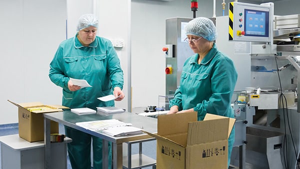 Two employees working in a pharmacy Supply Chain
