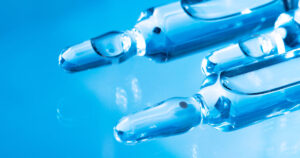 Transparent ampules on a blue background