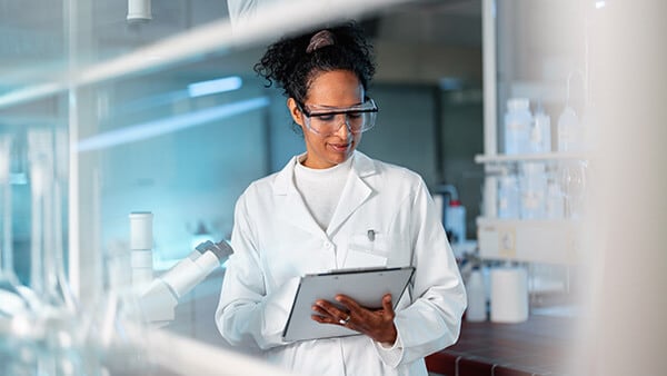 woman in lab coat developing new technologies