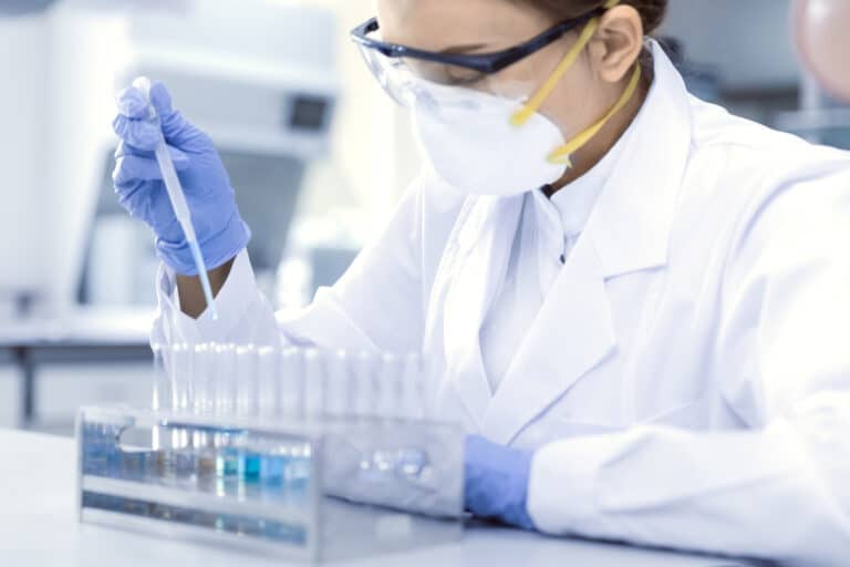 Scientist with test tubes for NIAD Funding